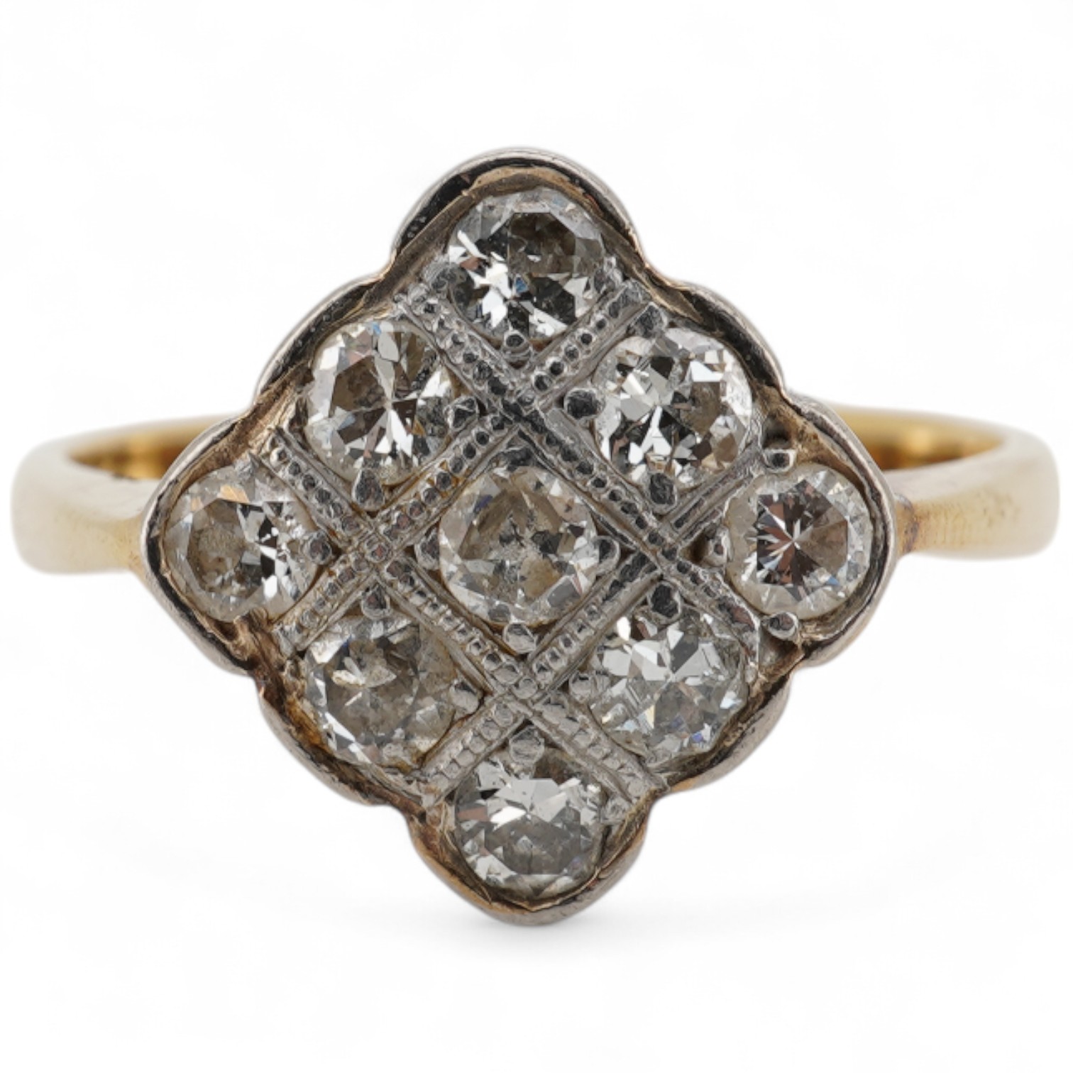 A yellow metal and nine stone millegrain set diamond cluster ring, of diamond form, size M, gross weight 2.9 grams.